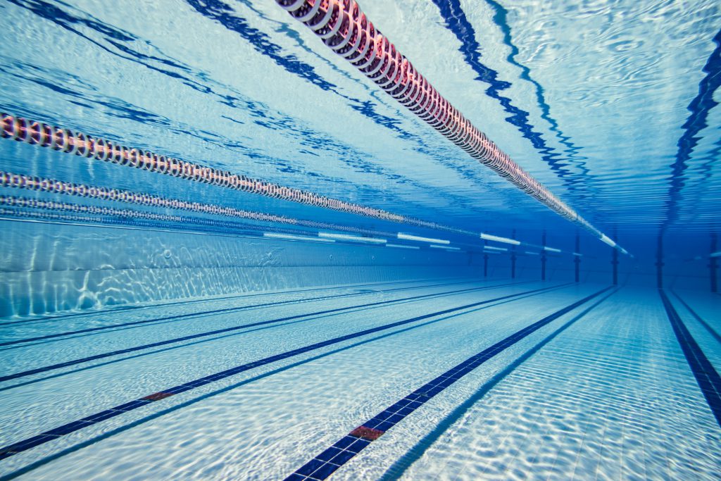 Olympic Swimming pool under water background.